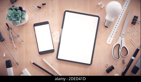 Responsive web design development. Work table with tablet, smartphone and other office items. Stock Photo