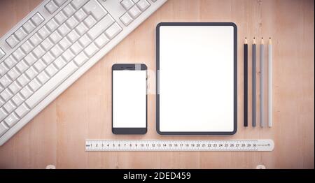 Responsive web design development. Work table with tablet, smartphone and keyboard. Stock Photo