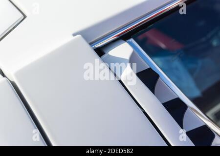 Close up of the top of the roof and right door pillar of a white Lamborghini Miura P400 S, showing the engine vents and detail of the body panels Stock Photo