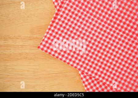 Classic pink plaid fabric or tablecloth in the corner of wood desk with copy space Stock Photo