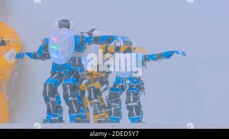 Humanoid robots dancing at robotic show Stock Photo