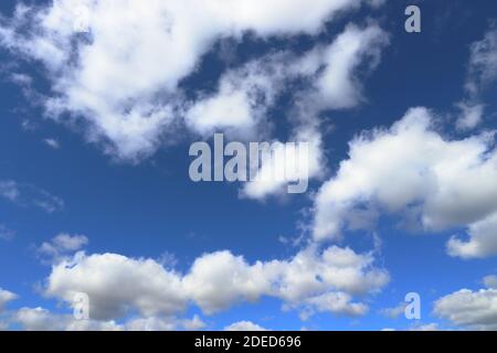 White clouds blue sky background. White fluffly clouds texture. Stock Photo