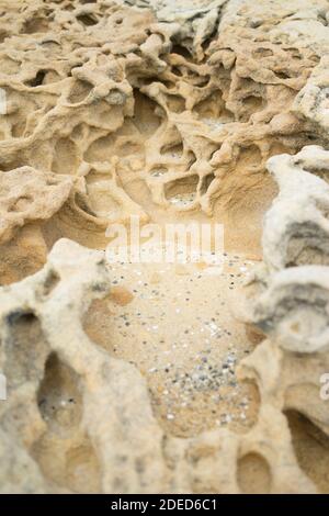 Sand and rock texture on the beach Stock Photo