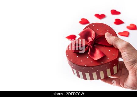 Female hands holding a gift box with heart shape for Valentine's Day Stock Photo