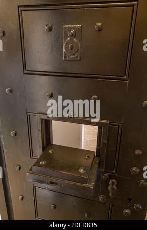 Open hatch on a typical male prison cell inside the Victorian Prison, Lincoln Castle, Lincs., UK. Stock Photo