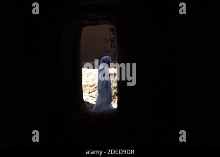 Lalibela/Ethiopia – April 12, 2019: Christians pilgrim in the tunnels connecting the rock hewn churches of Lalibela Stock Photo