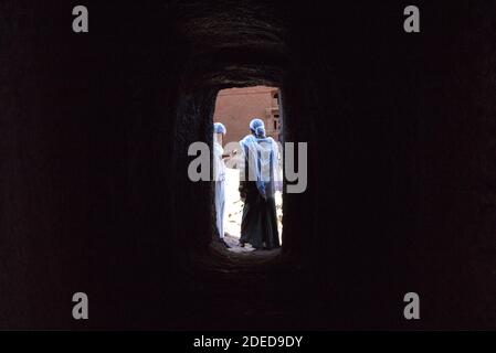 Lalibela/Ethiopia – April 12, 2019: Christians pilgrims in the tunnels connecting the rock hewn churches of Lalibela Stock Photo