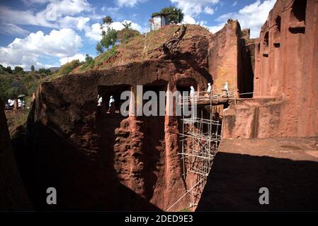Lalibela/Ethiopia – April 12, 2019: Christians pilgrims in the tunnels connecting the rock hewn churches of Lalibela Stock Photo
