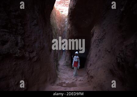 Lalibela/Ethiopia – April 12, 2019: Christian pilgrims in the tunnels connecting the rock hewn churches of Lalibela Stock Photo