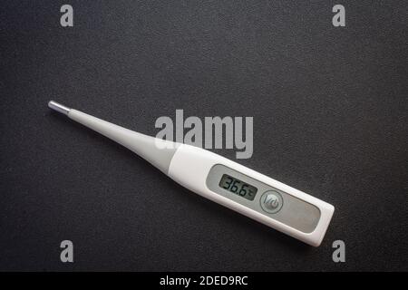 Premium Photo  Medical electronic thermometer on a black