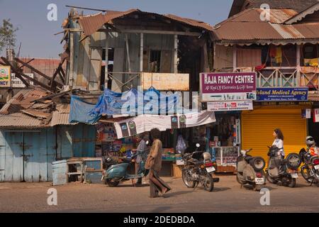 Activity on the main street of Port Blair in the Andaman Islands with shop frontages and people passing by, a typical third world country scene Stock Photo
