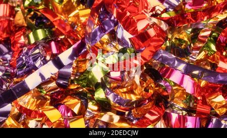 Large bright colorful Christmas foil decorations close up. Festive abstract texture and background Stock Photo