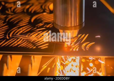 Laser cutting machine working with sheet metal with sparks - close up Stock Photo