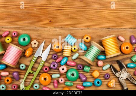 Colored wooden beads on a wooden table in a close up view with copy space Stock Photo