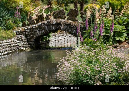 pretty old stone bridge reflecting in the river Stock Photo