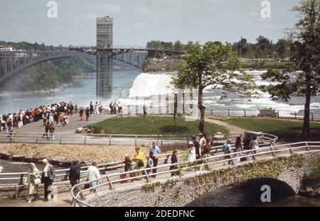 1970s Photo (1973) -  Luna Island on the American side of the Niagara River looking toward the American falls and observation tower. Rainbow Bridge in background Stock Photo