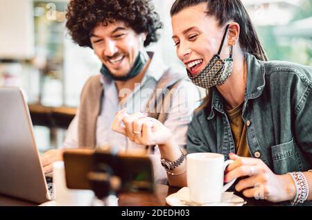 Young milenial influencers sharing creative content on streaming platform - Modern marketing concept with next generation couple having fun Stock Photo