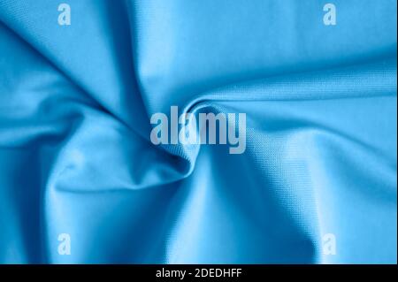 microfiber fabric blue color background with pleats, top view. toned classic blue color Stock Photo