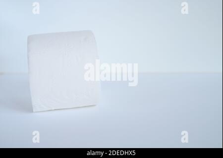 rolled white toilet paper in a white background. space for text Stock Photo
