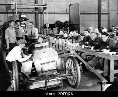 ROBERT MONTGOMERY WALLACE BEERY and CHESTER MORRIS on set candid with Movie Crew during filming of THE BIG HOUSE 1930 director GEORGE W. HILL story and dialogue Frances Marion Cosmopolitan Productions / Metro Goldwyn Mayer Stock Photo