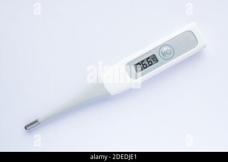 Electronic body thermometer displaying healthy human body temperature 36.6 grades C Stock Photo