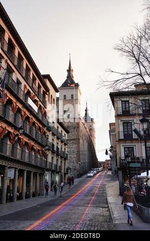 TOLEDO, SPAIN - MARCH 04, 2020: Typical street scenery in Toledo, Spain. Famous Alcazar fortress in historic old town. Stock Photo