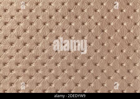 Texture of brown leather background with capitone pattern, macro. Bronze textile of retro Chesterfield style. Vintage fabric backdrop. Stock Photo