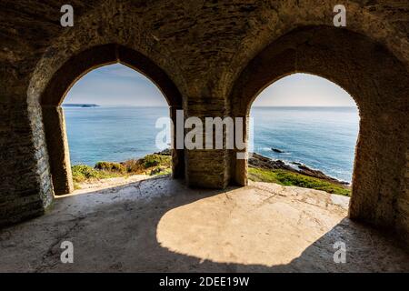 The view from inside Queen Adelaide's Chapel / Grotto at Penlee Point towards Rame Head, Cornwall England Stock Photo