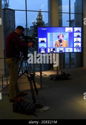 Berlin, Germany. 30th Nov, 2020. German Chancellor Angela Merkel (M) can be seen on a monitor as she talks to police officers at an online meeting in the Chancellery. Credit: Annegret Hilse/Reuters Images Europe/Pool/dpa/Alamy Live News Stock Photo