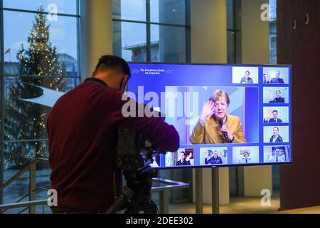 Berlin, Germany. 30th Nov, 2020. German Chancellor Angela Merkel (M) can be seen on a monitor as she talks to police officers at an online meeting in the Chancellery. Credit: Annegret Hilse/Reuters Images Europe/Pool/dpa/Alamy Live News Stock Photo