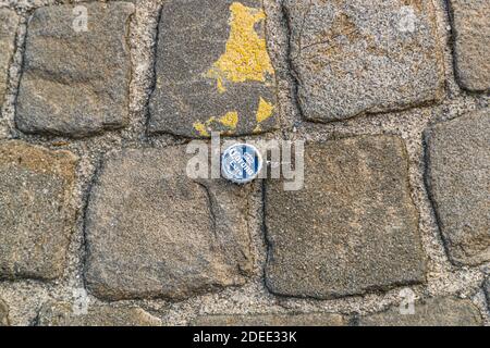 Corona bottle cap on the pavement in Zurich, Switzerland Stock Photo