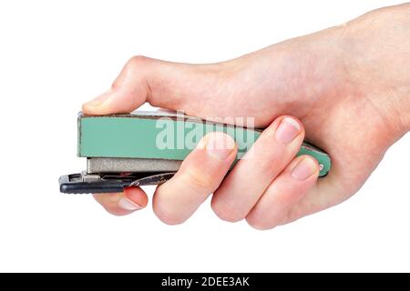 A big office stapler in hand, finger pressing the top part. Simple stapling gesture isolated on white background, cut out, closeup, side view Stock Photo