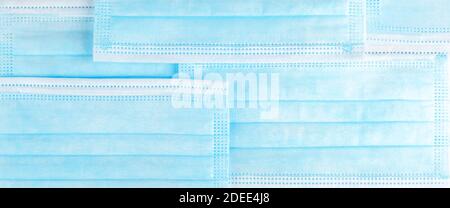 Blue protective surgical face masks structure, pattern closeup, wide abstract medical background texture, banner. Health care backdrop, corona virus p Stock Photo