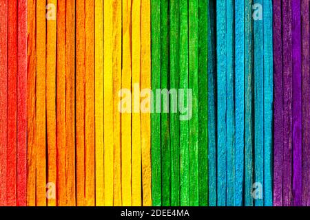 Simple full rainbow backdrop, colorful wooden popsicle sticks backdrop. Abstract multi colored natural background wall texture. Education, freedom Stock Photo