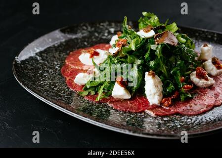 marble beef carpaccio on a black background Stock Photo
