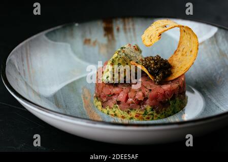 fresh marbled beef tartare on a black background Stock Photo