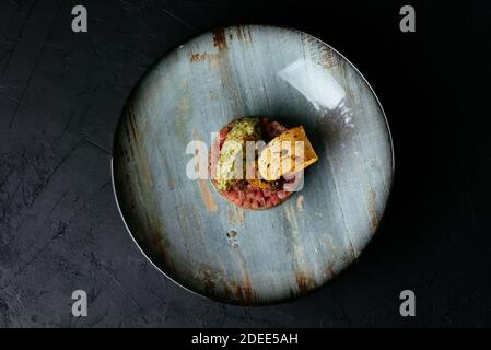 fresh marbled beef tartare on a black background Stock Photo