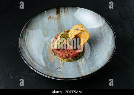 fresh marbled beef tartare on a black background Stock Photo