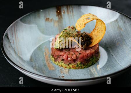 fresh marbled beef tartare on a black background Stock Photo
