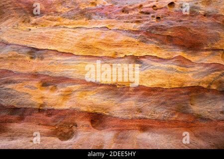 The multi-colored exposed sandstone rock and mineral layers in the ancient tombs of Petra, Jordan.Sandstone pattern,geological texture in Petra,Jordan Stock Photo