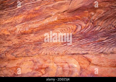 Spectacular colors, shapes and patterns naturally created in Petra's red sand rocks. Background, Texture, Copy space Stock Photo