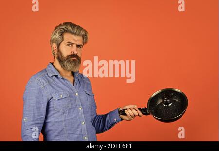 Nonstick pan coated polytetrafluoroethylene teflon. Man hold new brand pan.  Shop buy kitchen goods. Shopping kitchenware. Cooking utensils. Enameled  cast iron cooking vessels. Saucepan glass lid Stock Photo - Alamy