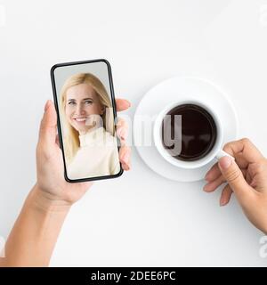 Mother And Daughter Having Online Video Call Via Smartphone, Cropped Stock Photo