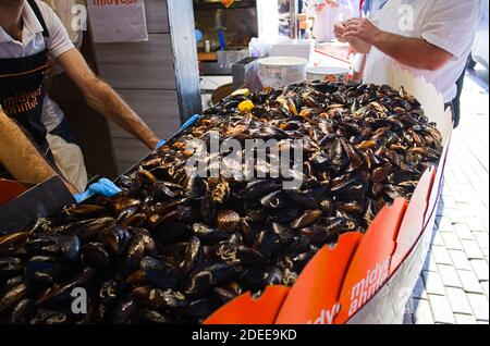 Istanbul, Turkey - September, 2018: Heap of mussels in shells stuffed with rice and served with lemon. Midye is traditional Turkish food. Stock Photo