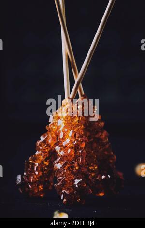 Candy cane sugar, brown sugar sticks on a dark table, selective focus Stock Photo