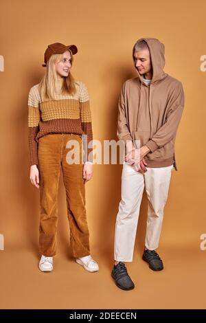 two stylish man and woman looking at each other studying, wearing trendy clothes, portrait. the first meeting Stock Photo