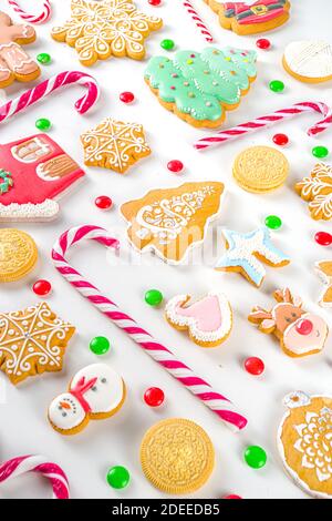 Christmas sweets set. Assorted festive Christmas and New Year sweets, traditional candy and cookie. Flatlay with candy cane candies, gingerbread, swee Stock Photo