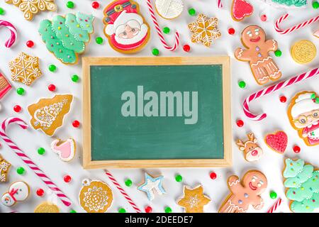 Christmas sweets set. Assorted festive Christmas and New Year sweets, traditional candy and cookie. Flatlay with candy cane candies, gingerbread, swee Stock Photo