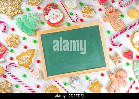 Christmas sweets set. Assorted festive Christmas and New Year sweets, traditional candy and cookie. Flatlay with candy cane candies, gingerbread, swee Stock Photo