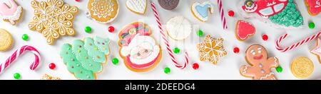 Christmas sweets set. Assorted festive Christmas and New Year sweets, traditional candy and cookie. Flatlay with candy cane candies, gingerbread, swee Stock Photo